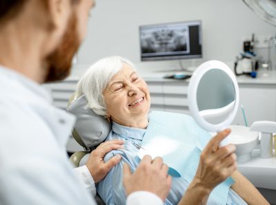 a patient is thrilled that her dental implants look like real teeth